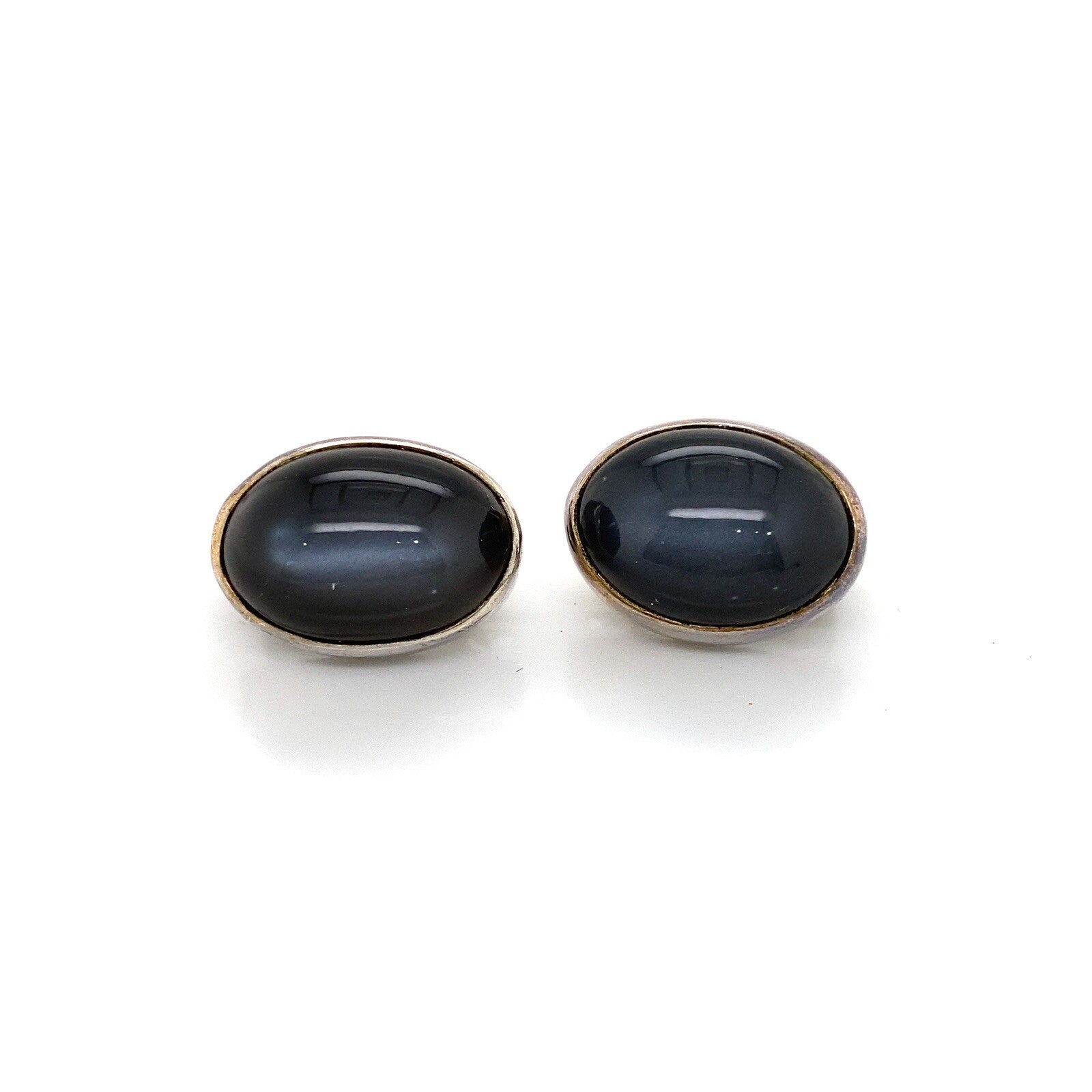 Stephen Dweck silver clip earrings with oval cabochon black Diopside stone. — Certified Authentic | San Diego Jewelry Buyers